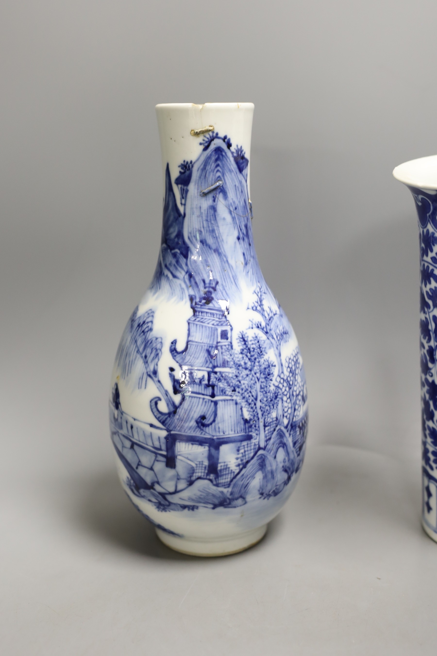 A 19th century Chinese blue and white ‘landscape’ vase, an early 20th century blue and white sleeve vase and three blue and white jars and covers. Tallest 25.5cm